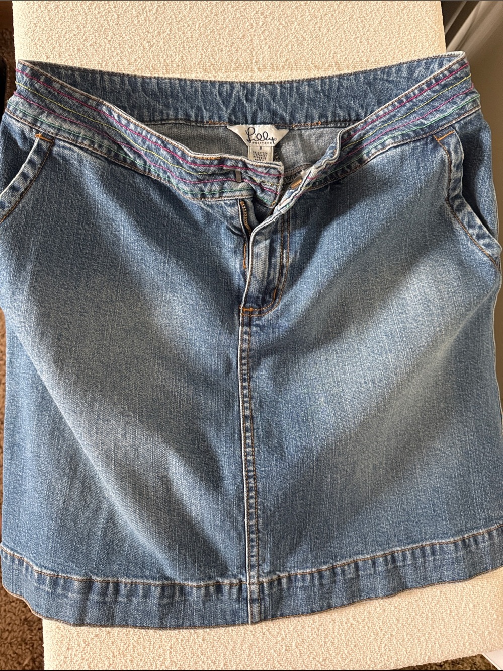 Lilly Pulitzer, colorful ribbon, back pockets, mini denim skirt. A unique find!